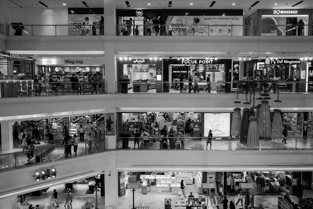 a-black-and-white-photo-of-a-shopping-mall-ld5xoohvyo