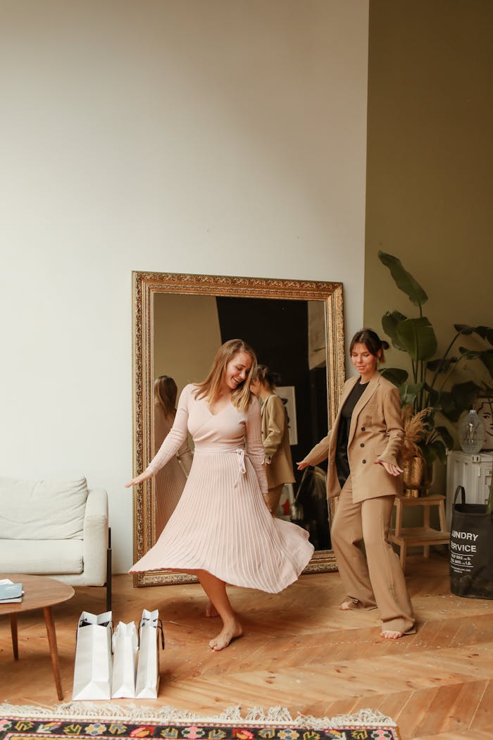 Two women having fun at home after a shopping spree, surrounded by plants and decor.